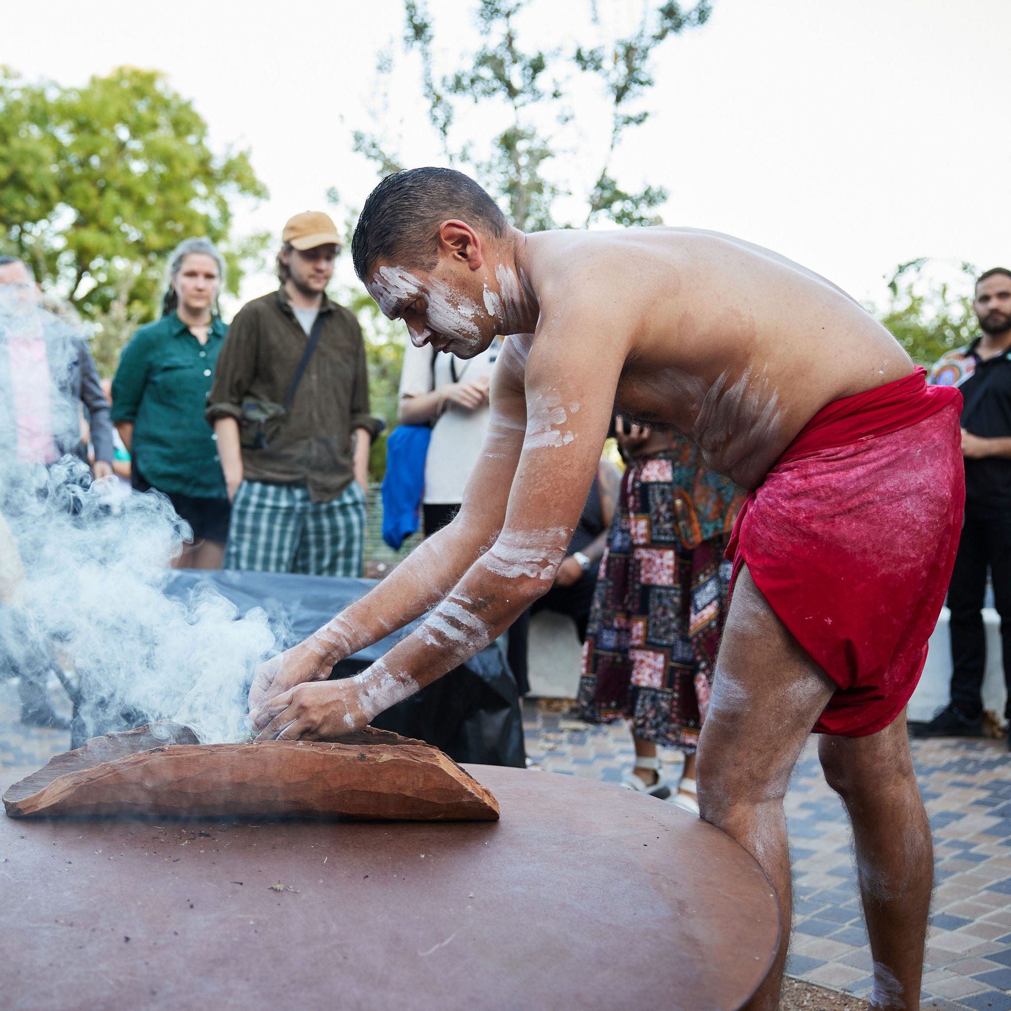 Aboriginal man conducting traditional Smoking Ceremony