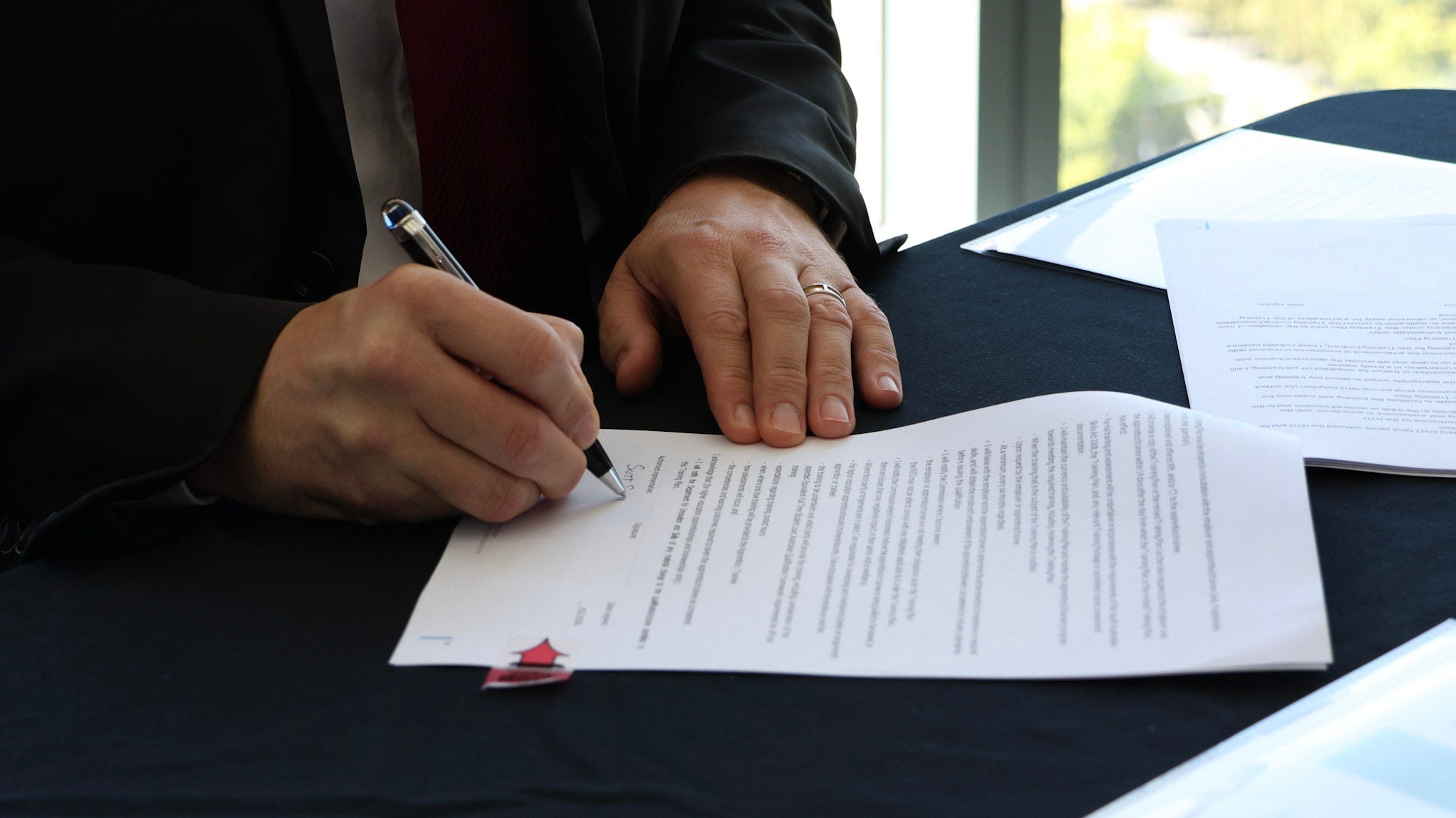 man signing a new contract