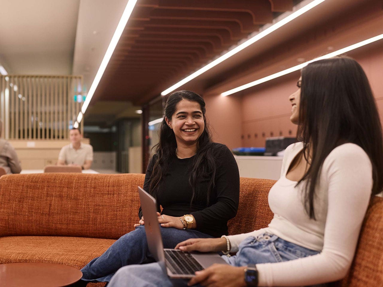 Two female students on campus having a conversation