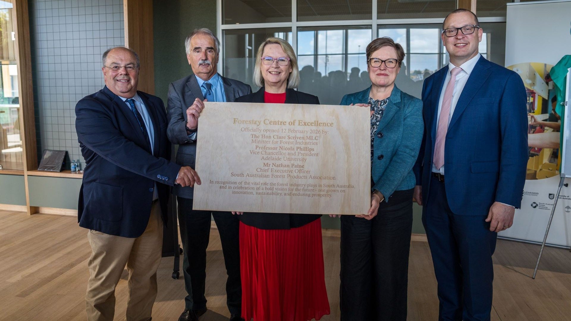 Group of people unveiling a plaque 