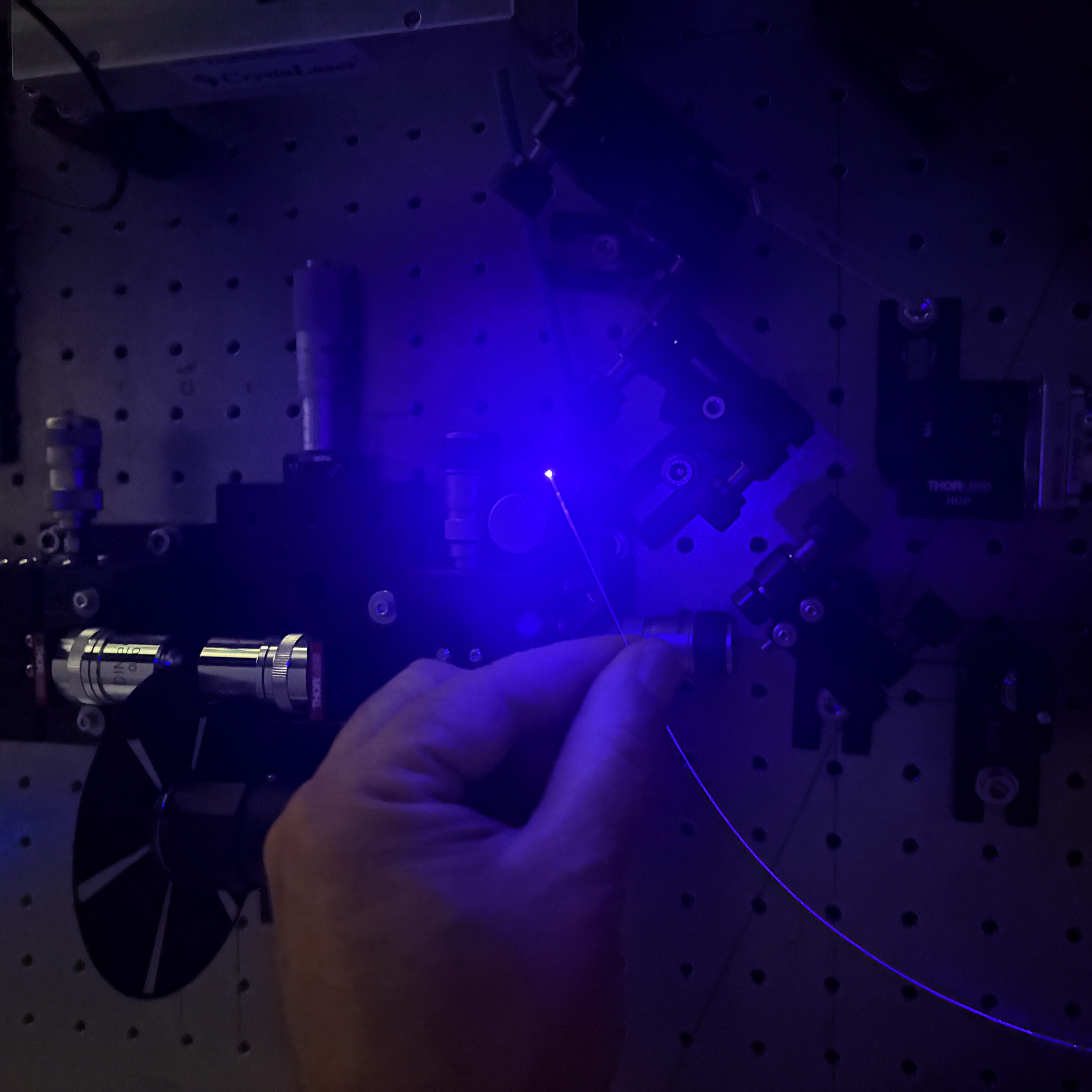 Fibre optic probe in small beaker of water.